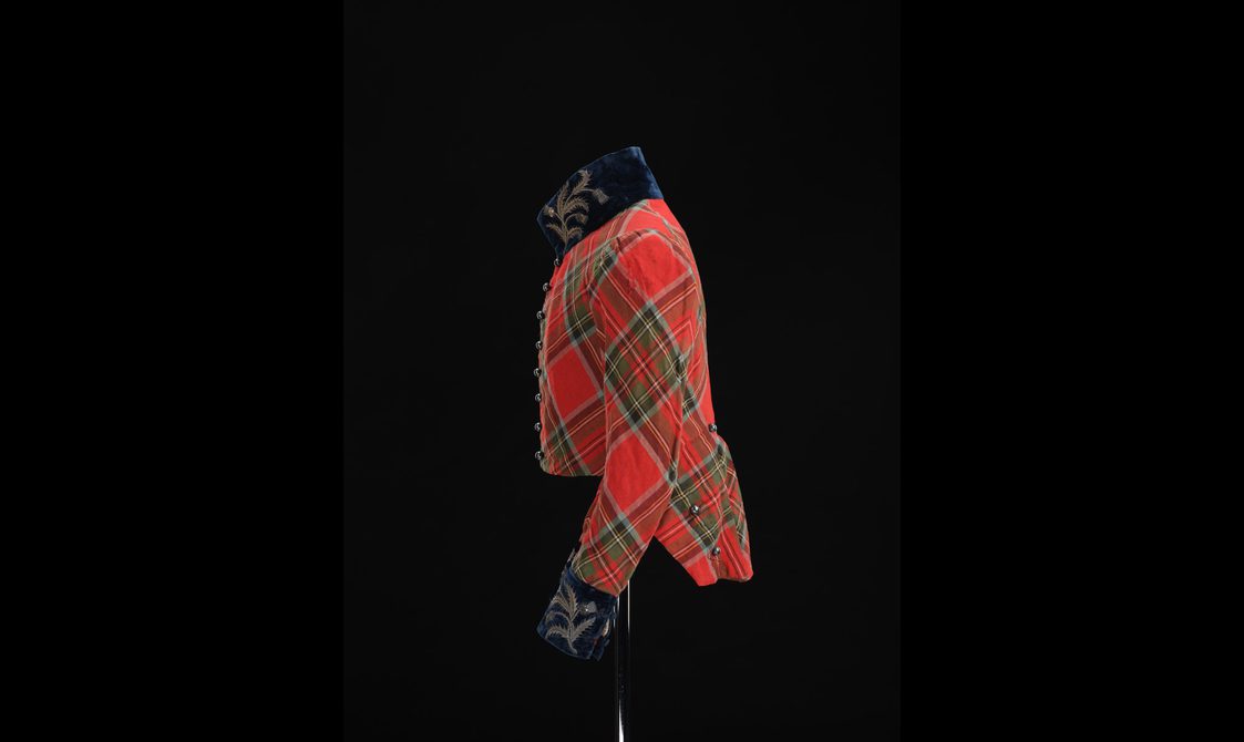 Side view of a mannequin wearing a short red tartan jacket