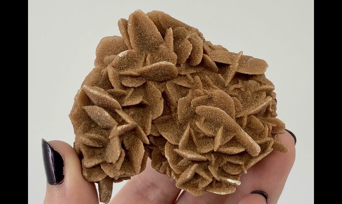 A brown mineral with a surface that appears sandy.