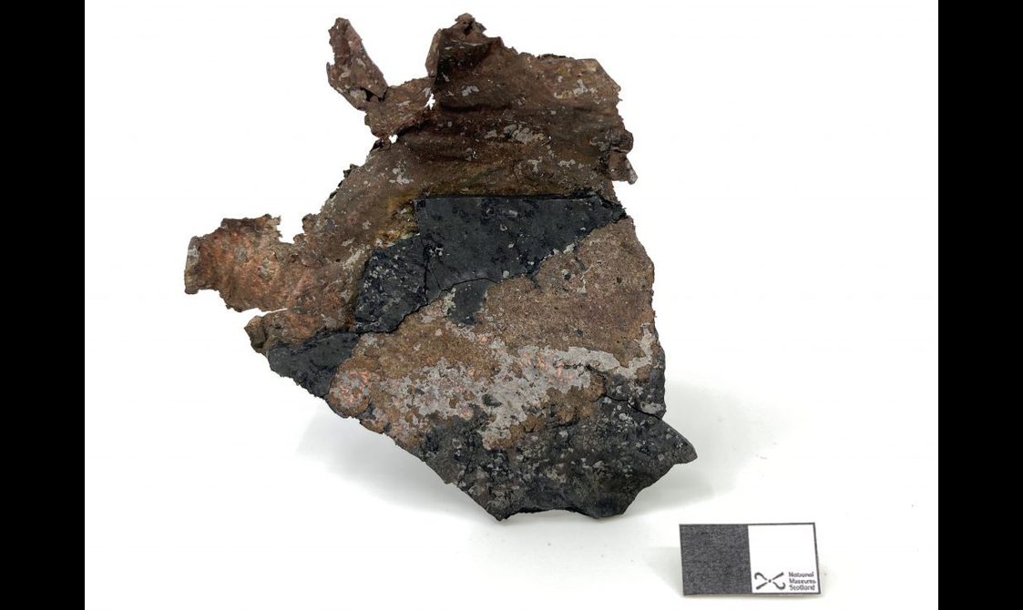 Sheet of copper attached to a piece of slate