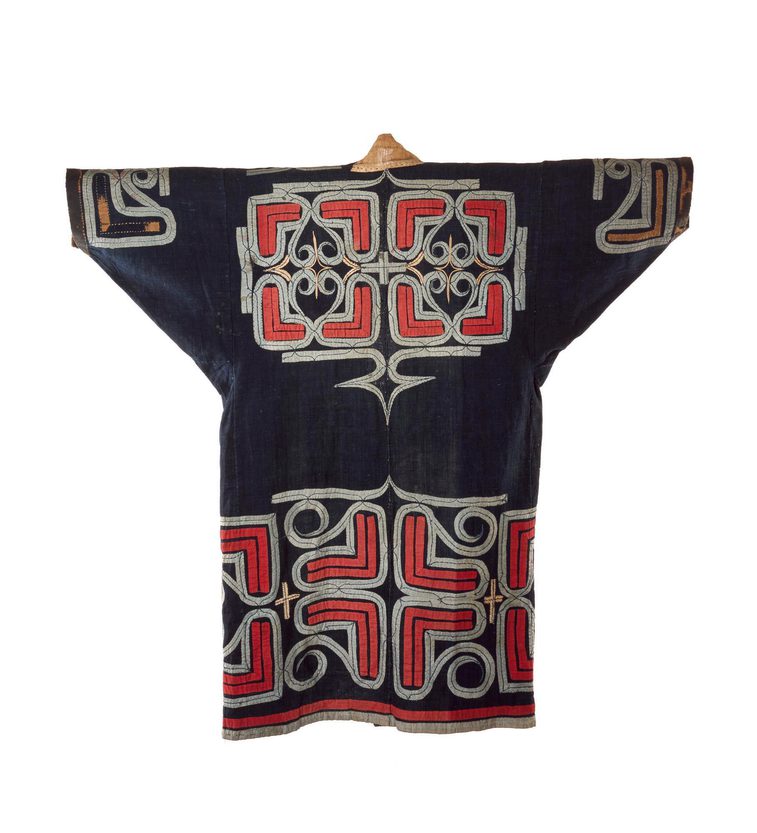 A black robe with wide sleeves with red geometric patterns