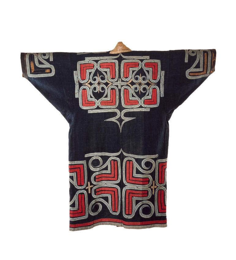 A black robe with wide sleeves with red geometric patterns