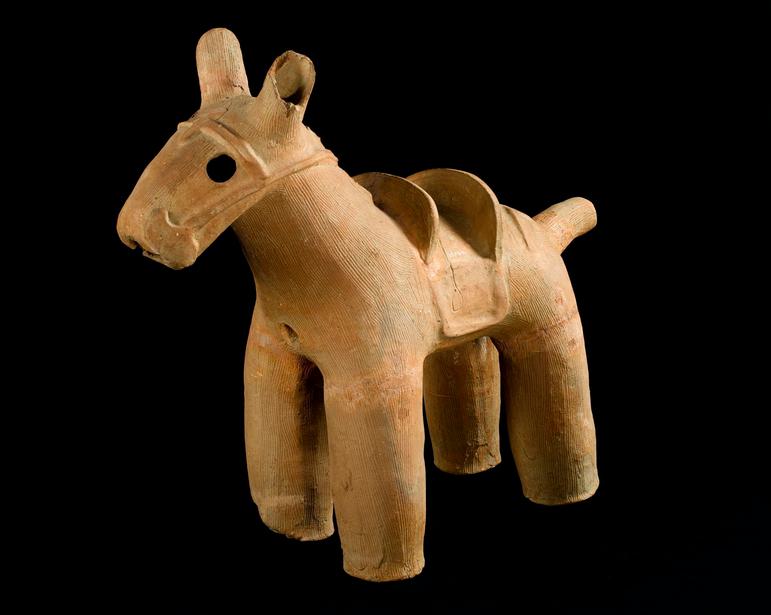 A horse made out of pottery in an earthy light brown colour