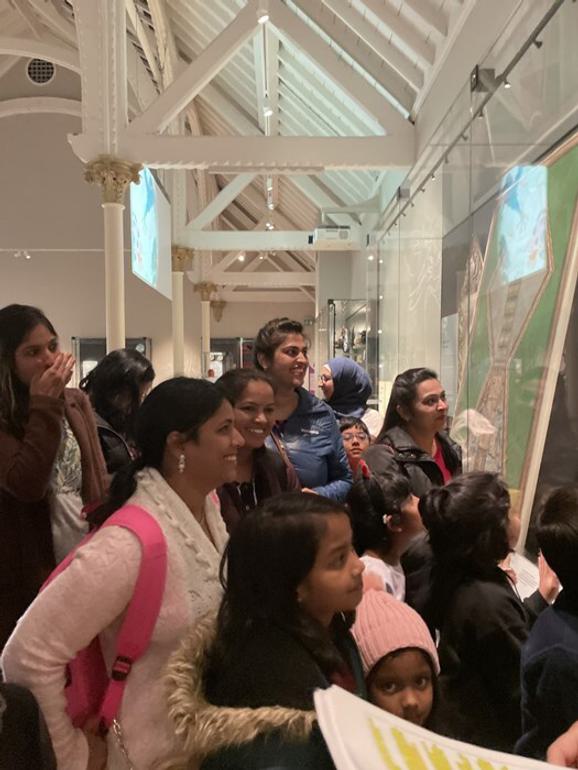 A group of people are stood engaged in discussion