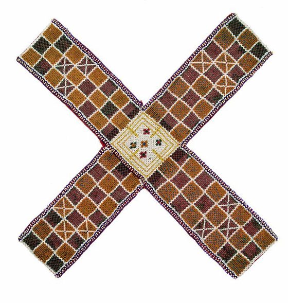 A woven mat in an "X" shape, featuring a chequer pattern