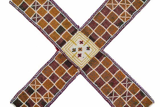 A woven mat in an "X" shape, featuring a chequer pattern