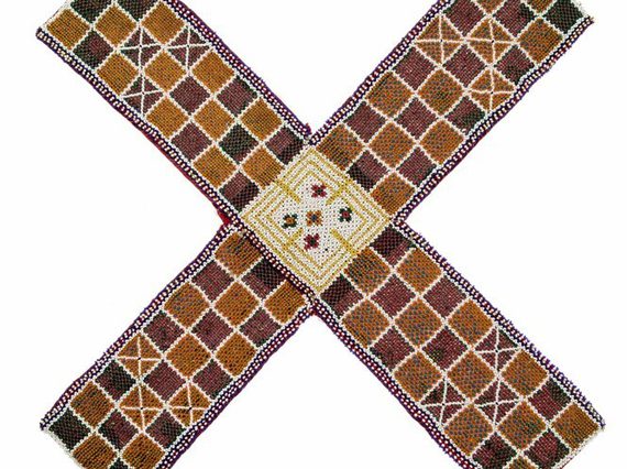 A woven mat in an "X" shape, featuring a chequer pattern