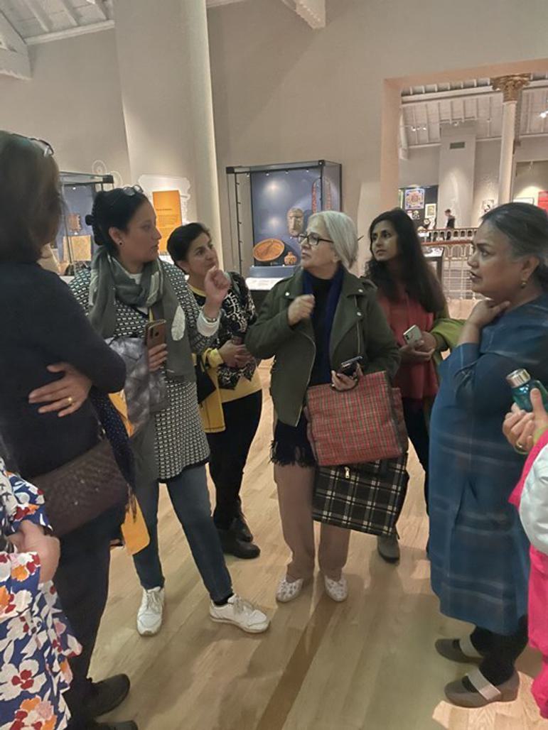 A group of people standing together are in discussion