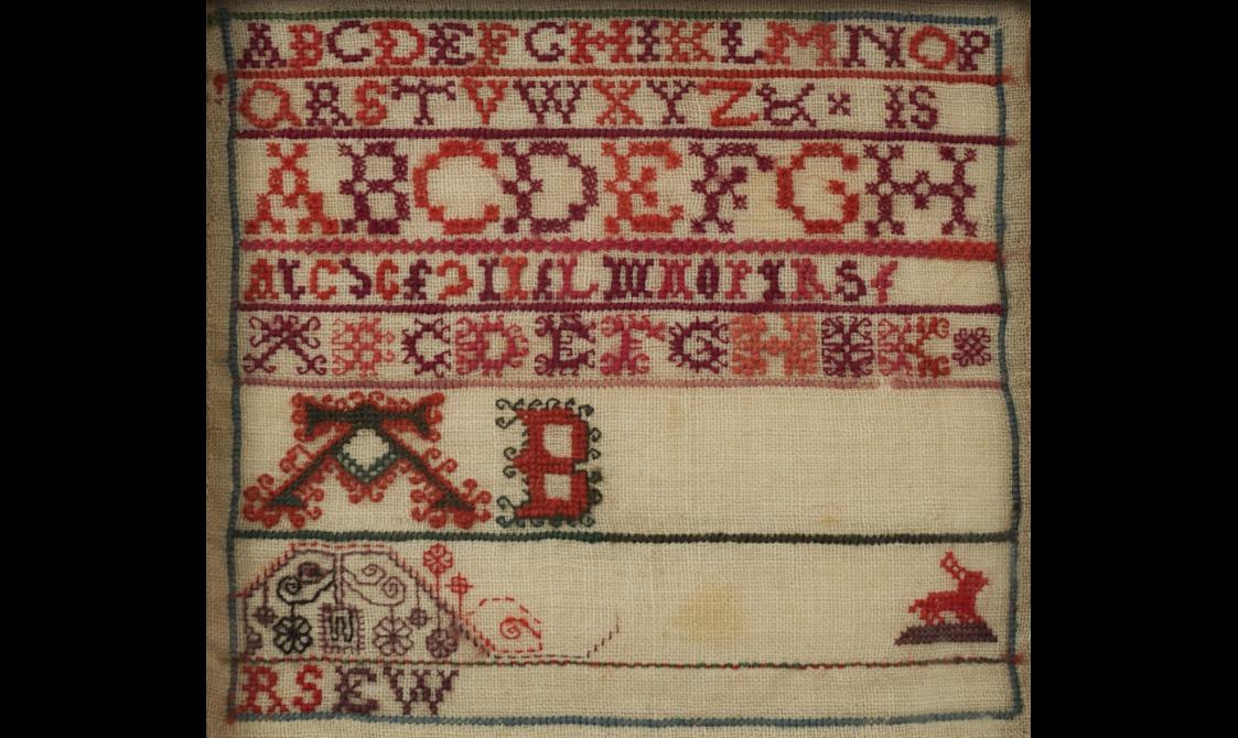 A needlework sampler of the alphabet.
