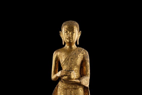 A Buddha sculpture holding an alms bowl.