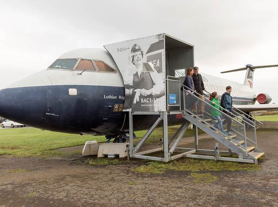 A family exiting a BAC 1-11 aircraft on a flight of stairs