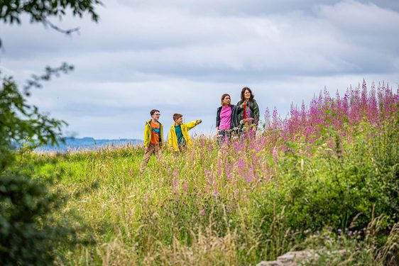 A family walking through the countryside in East Kilbride.