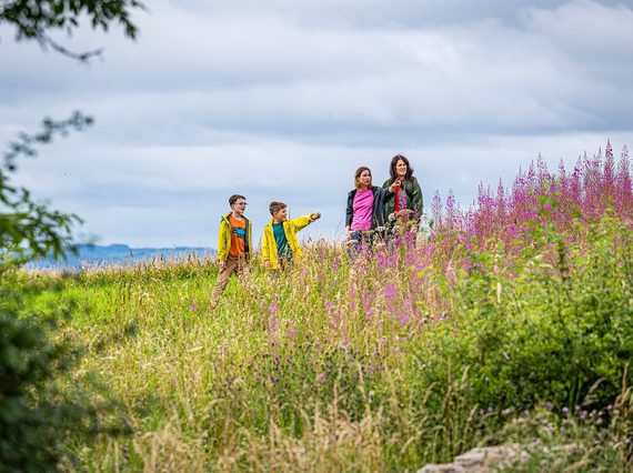 A family walking through the countryside in East Kilbride.