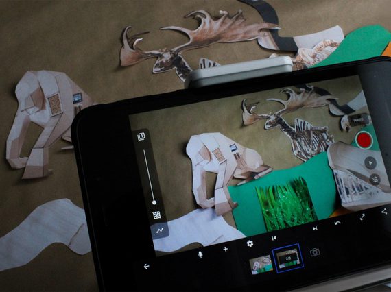 A smartphone camera with a view of a collage of different prehistoric creatures