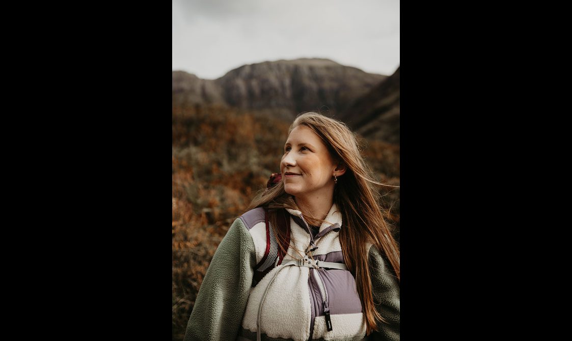 Headshot of Eilidh Sykes in a rural landscape