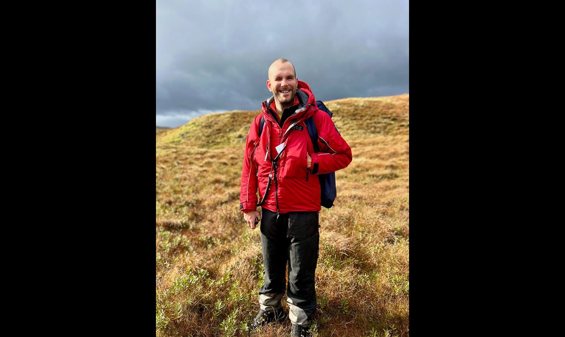 Portrait of Ross Christie standing on a hill