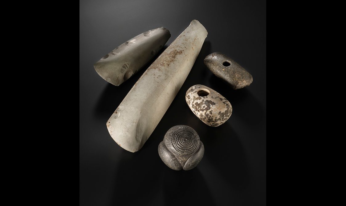 Five stone objects - two axe heads, two mace heads and a carved stone ball
