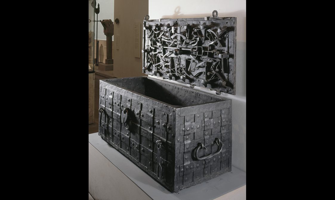 A large metal chest with intricate metalwork on the lid