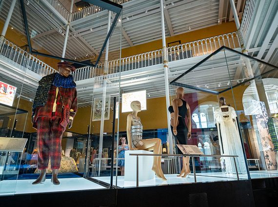 A view of the Fashion and Style gallery in the National Museum of Scotland featuring four mannequins in different poses