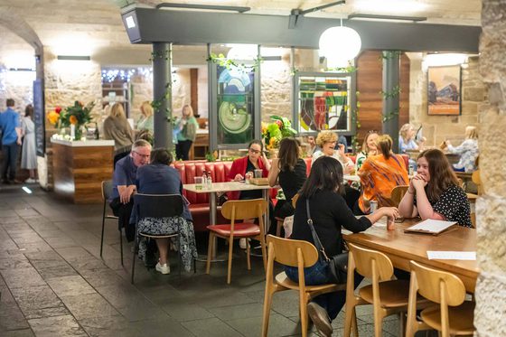People sitting in a restaurant eating food.