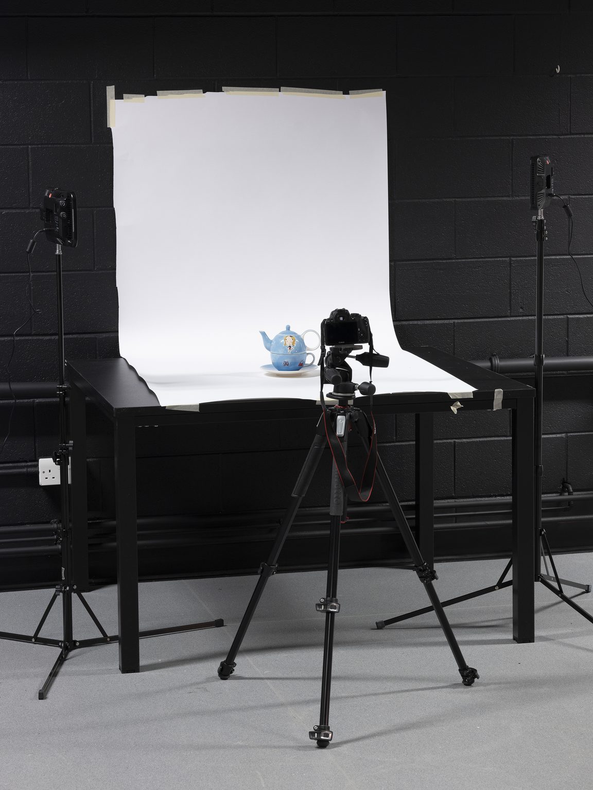 A teapot being photographed in a studio