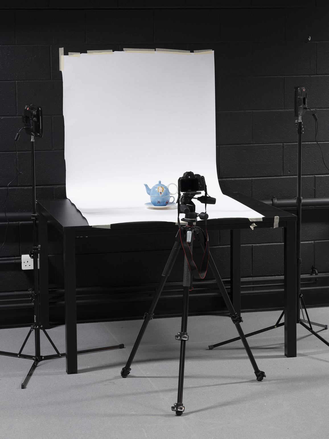 A teapot being photographed in a studio
