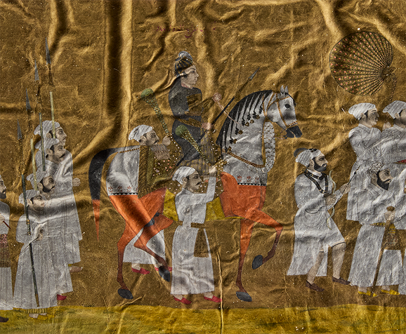 A crinkled gold painting close up of a man on horseback.