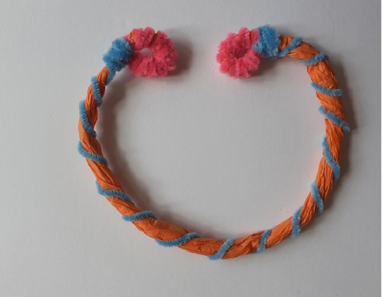 A handmade necklace crafted from colourful tissue paper and pipe cleaners.