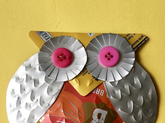 A stylish owl badge crafted from a fizzy drink can.