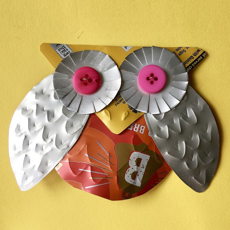 A stylish owl badge crafted from a fizzy drink can.