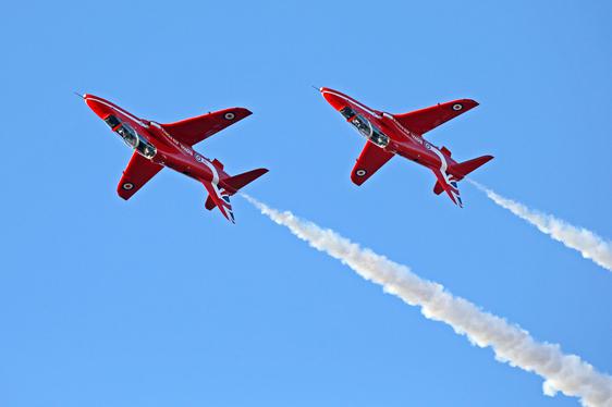 Two Red Arrow Hawk aircraft flying upside down.